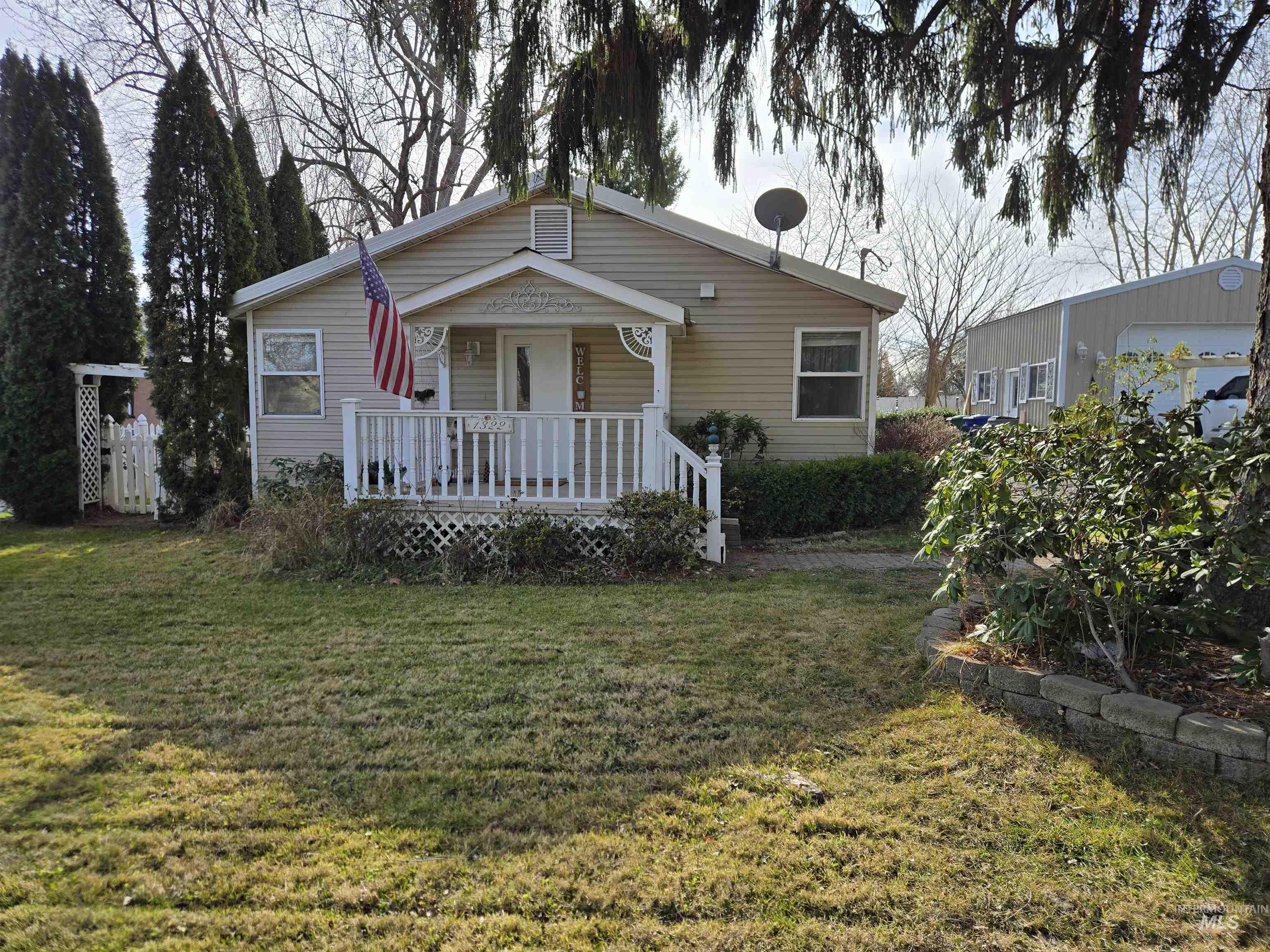 Bungalow-style home with covered porch and a front yard