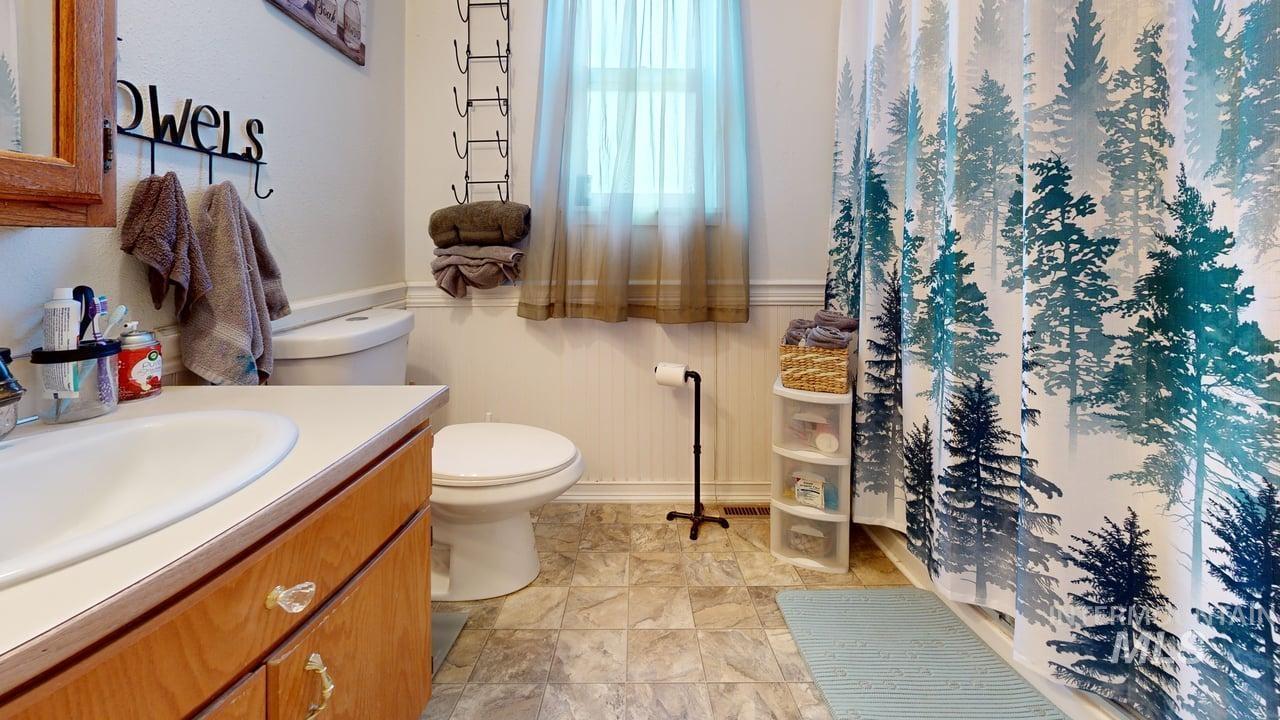 1322 Grelle Avenue Lewiston, ID 83501 - Photo 14 of 22 Full bathroom with a wainscoted wall, vanity, and a shower with shower curtain
