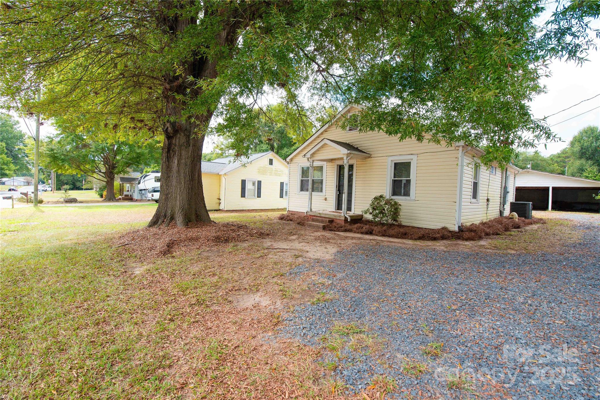 207 North Love Chapel Road Stanfield, NC 28163 - Photo 3 of 21 a white house that has a tree in front of it