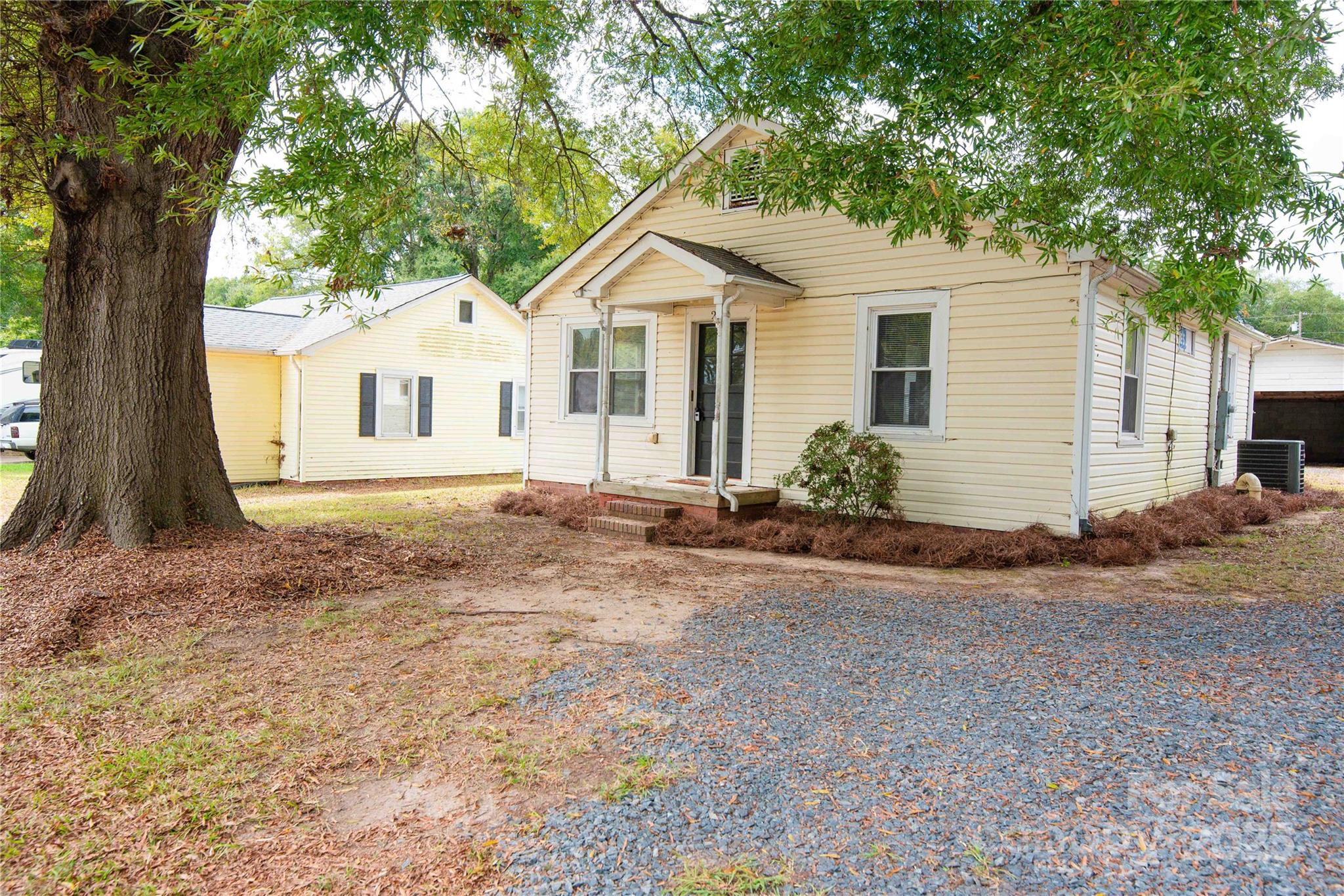 207 North Love Chapel Road Stanfield, NC 28163 - Photo 5 of 21 a front view of a house with a yard and garage