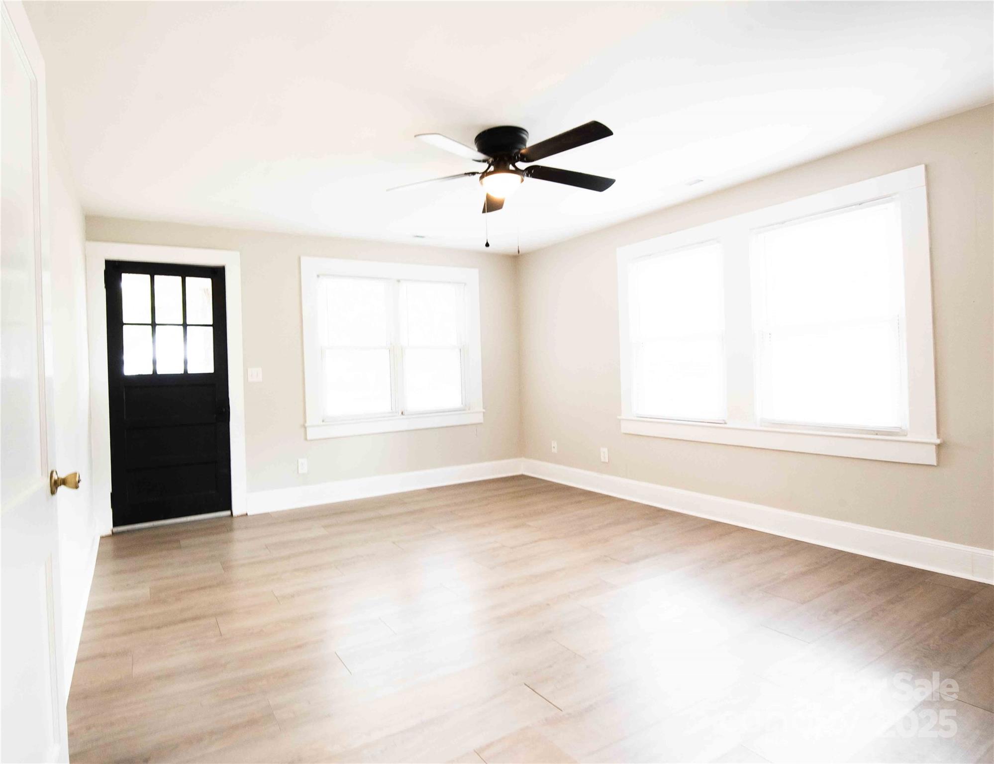 207 North Love Chapel Road Stanfield, NC 28163 - Photo 8 of 21 an empty room with windows and cabinet