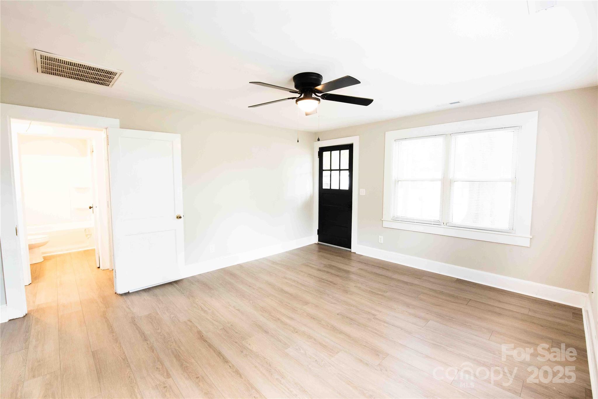 207 North Love Chapel Road Stanfield, NC 28163 - Photo 9 of 21 a view of an empty room with wooden floor and a window