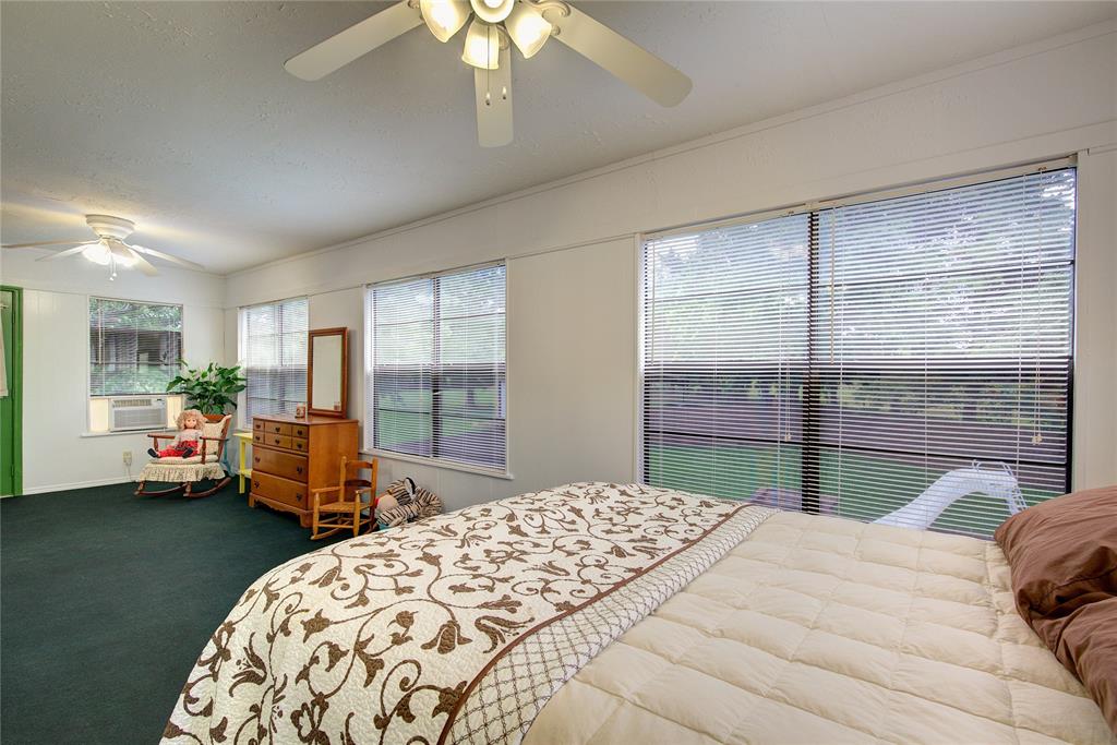 753 County Rd SW 3110 Mount Vernon, TX 75457 - Photo 26 of 40 This sunroom off of the primary upstairs suite has wall of windows overlooking the pool and a separate AC unit. Opens onto a 2nd-floor balcony.