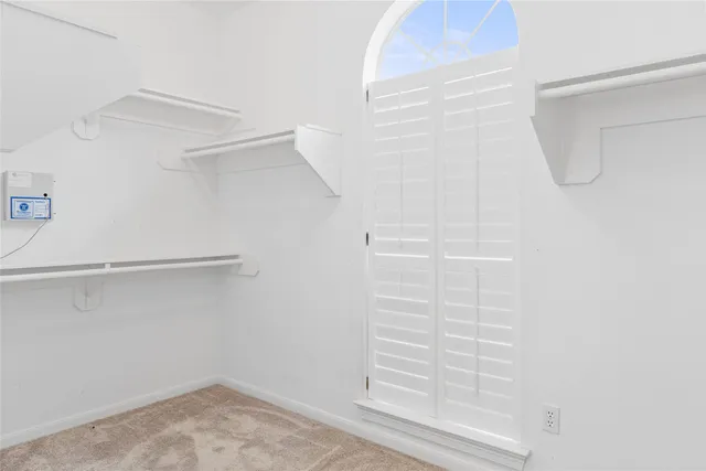 a view of walk in closet with empty racks