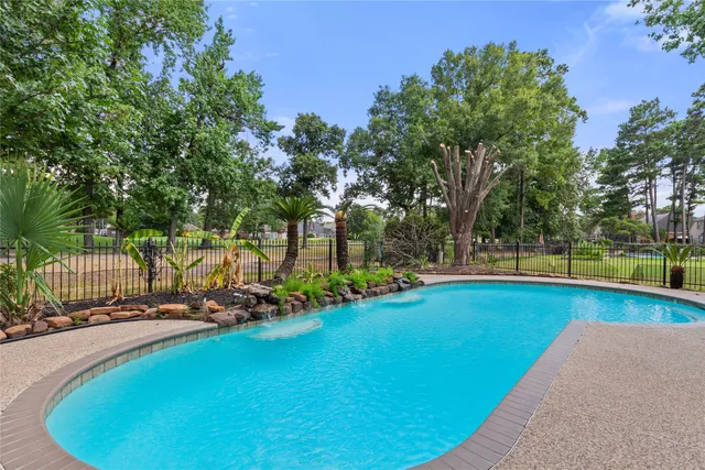 a view of a swimming pool with an outdoor seating and a yard