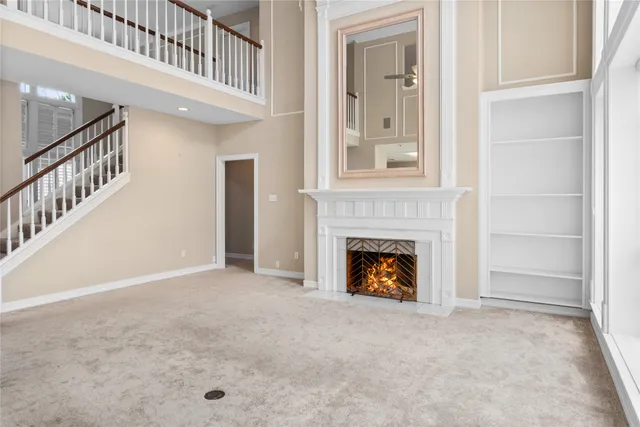 a view of an empty room and fire place