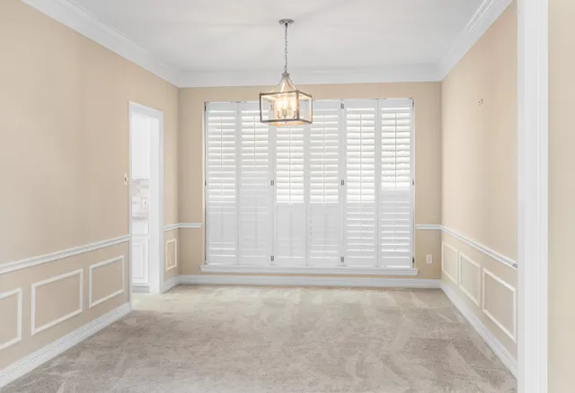 an empty room with windows and entrance