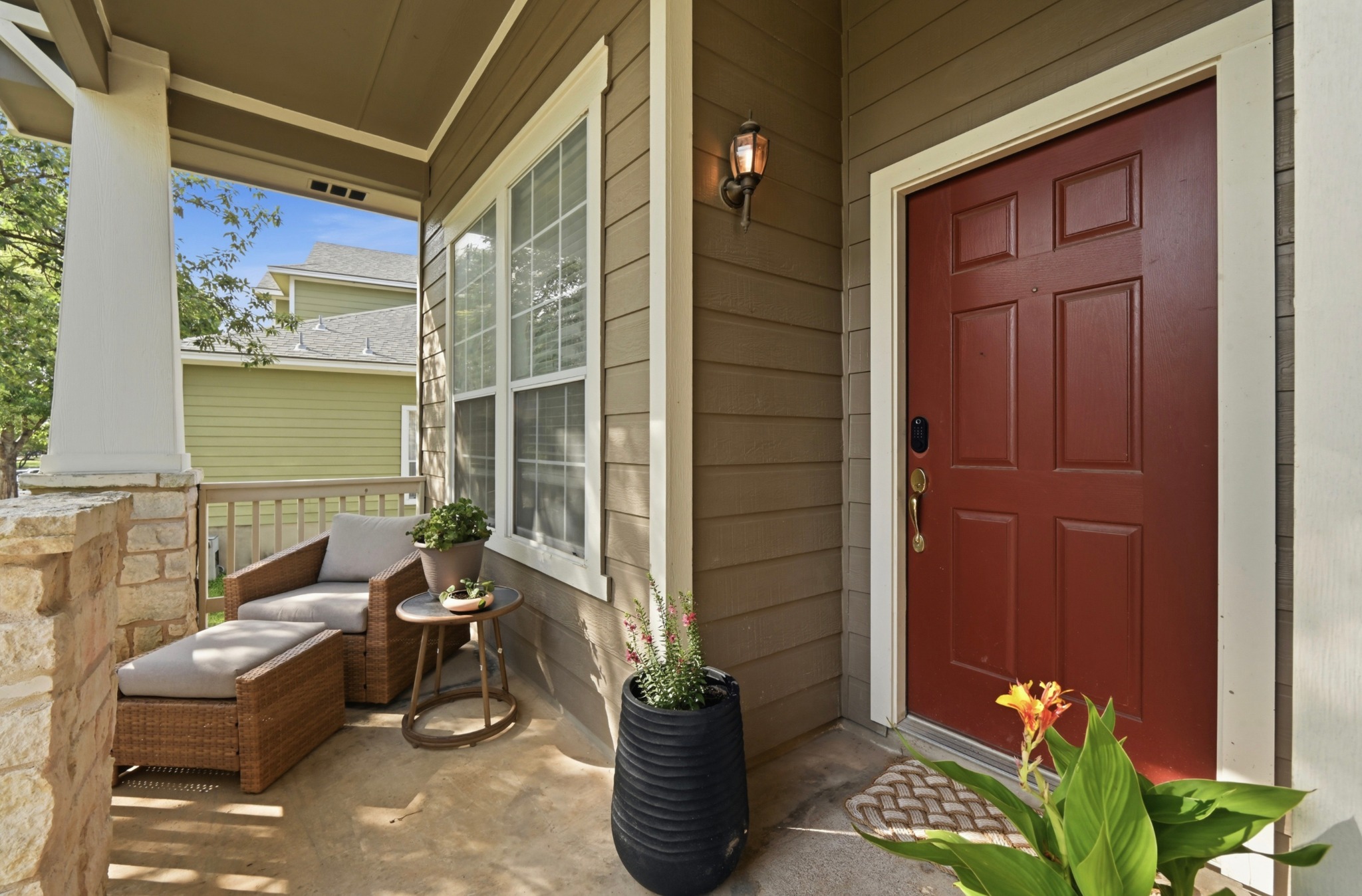 5888 Fergus Kyle, TX 78640 - Photo 33 of 40 A welcoming front porch features a durable stone foundation and comfortable outdoor seating.