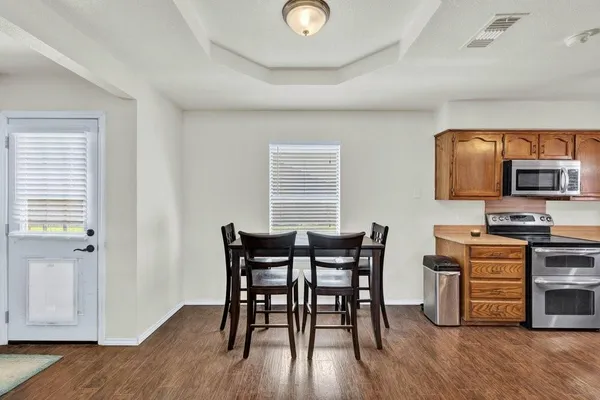a view of a dining room with furniture and wooden floor