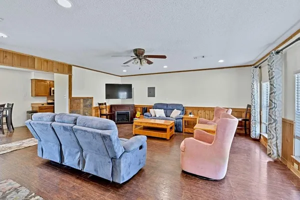 a living room with furniture ceiling fan and a rug