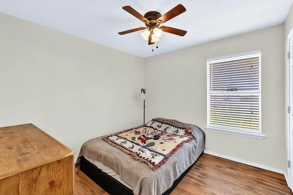 a bedroom with a bed and a window