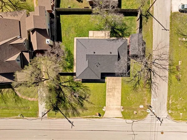 an aerial view of a house with a yard