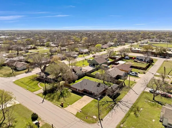 an aerial view of residential houses with outdoor space