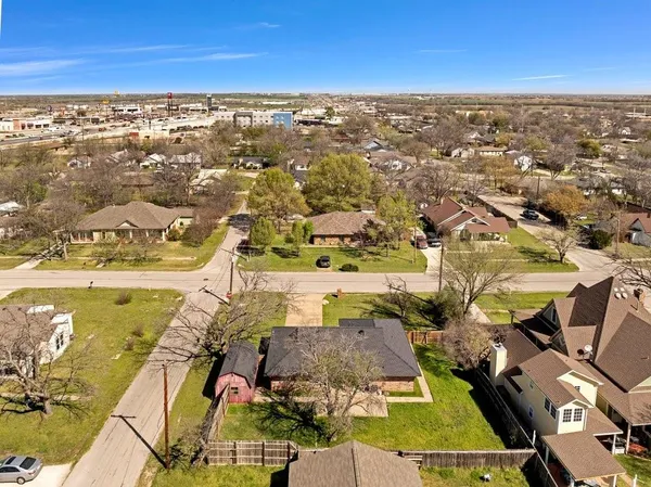 an aerial view of residential houses with outdoor space