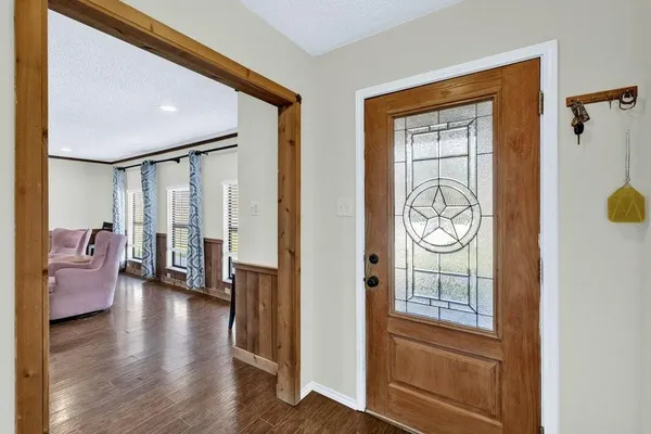 a en suite bathroom with a granite countertop sink and a mirror