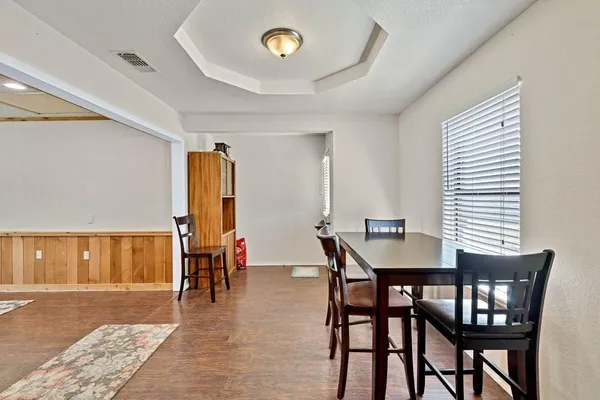 a dining room with furniture and window