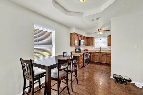 a view of a dining room with furniture and wooden floor