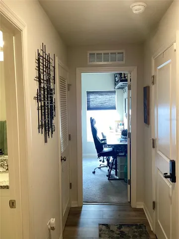 a view of living room kitchen with stainless steel appliances granite countertop furniture and a flat screen tv