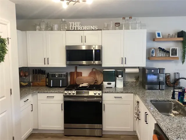 a kitchen with sink and refrigerator