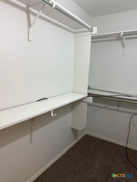 200 Utterback, Unit A Kyle, TX 78640 - Photo 13 of 19 a view of walk in closet with empty racks