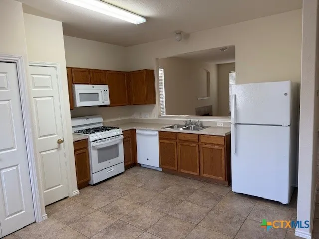 a kitchen with a refrigerator stove and sink