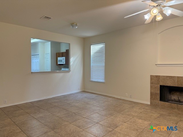 200 Utterback, Unit A Kyle, TX 78640 - Photo 8 of 19 a view of an empty room with window and chandelier fan