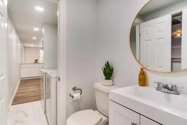 a bathroom with a sink toilet and shower