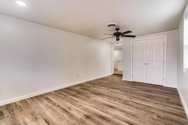 a view of empty room with ceiling fan