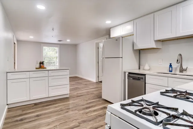 a kitchen with a stove a refrigerator and a sink