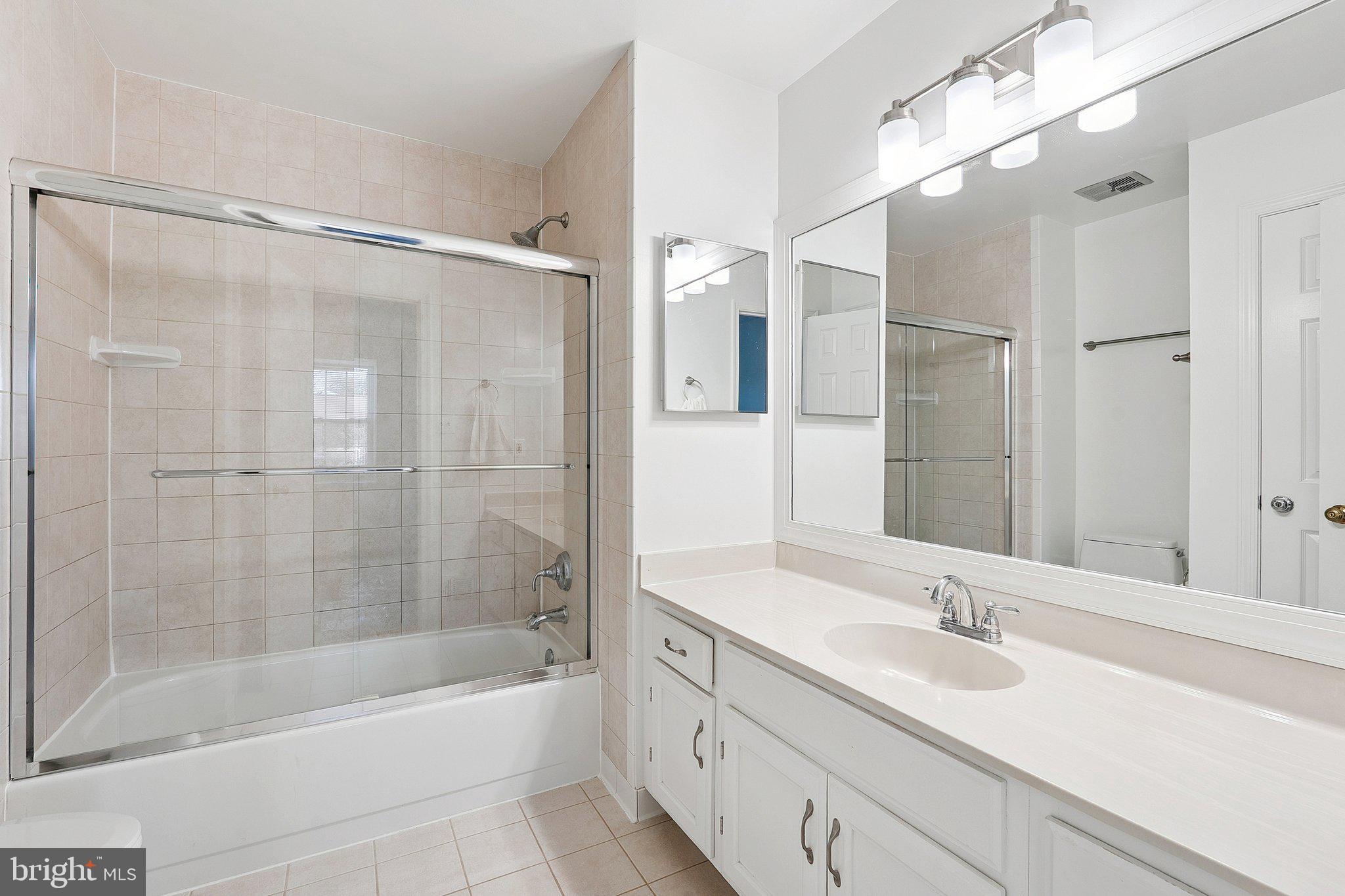3120 Valentino Court Oakton, VA 22124 - Photo 15 of 25 a bathroom with a bathtub shower sink vanity and mirror