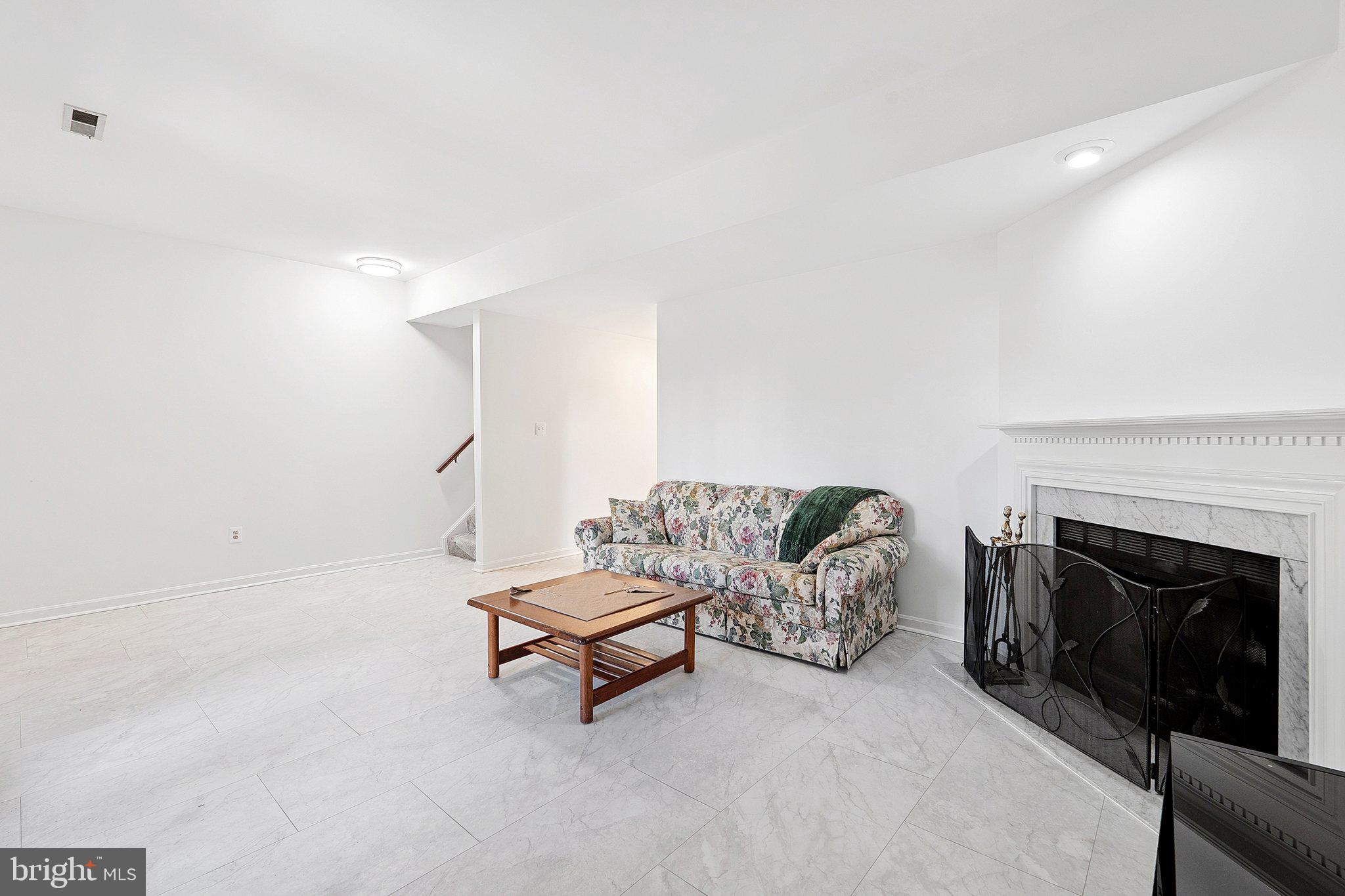 3120 Valentino Court Oakton, VA 22124 - Photo 20 of 25 a living room with furniture and a fireplace