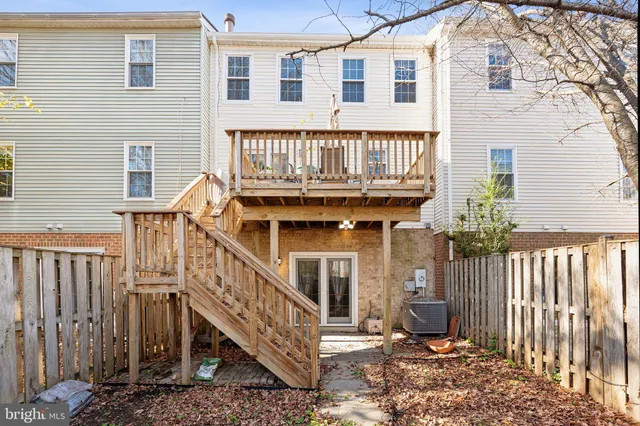 a view of a house with wooden fence