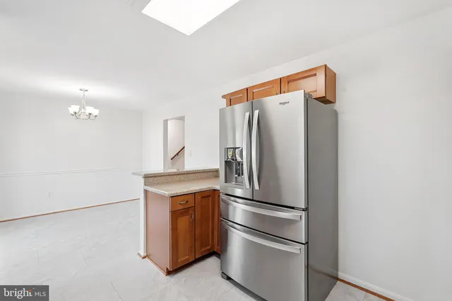a metallic refrigerator freezer sitting in a kitchen
