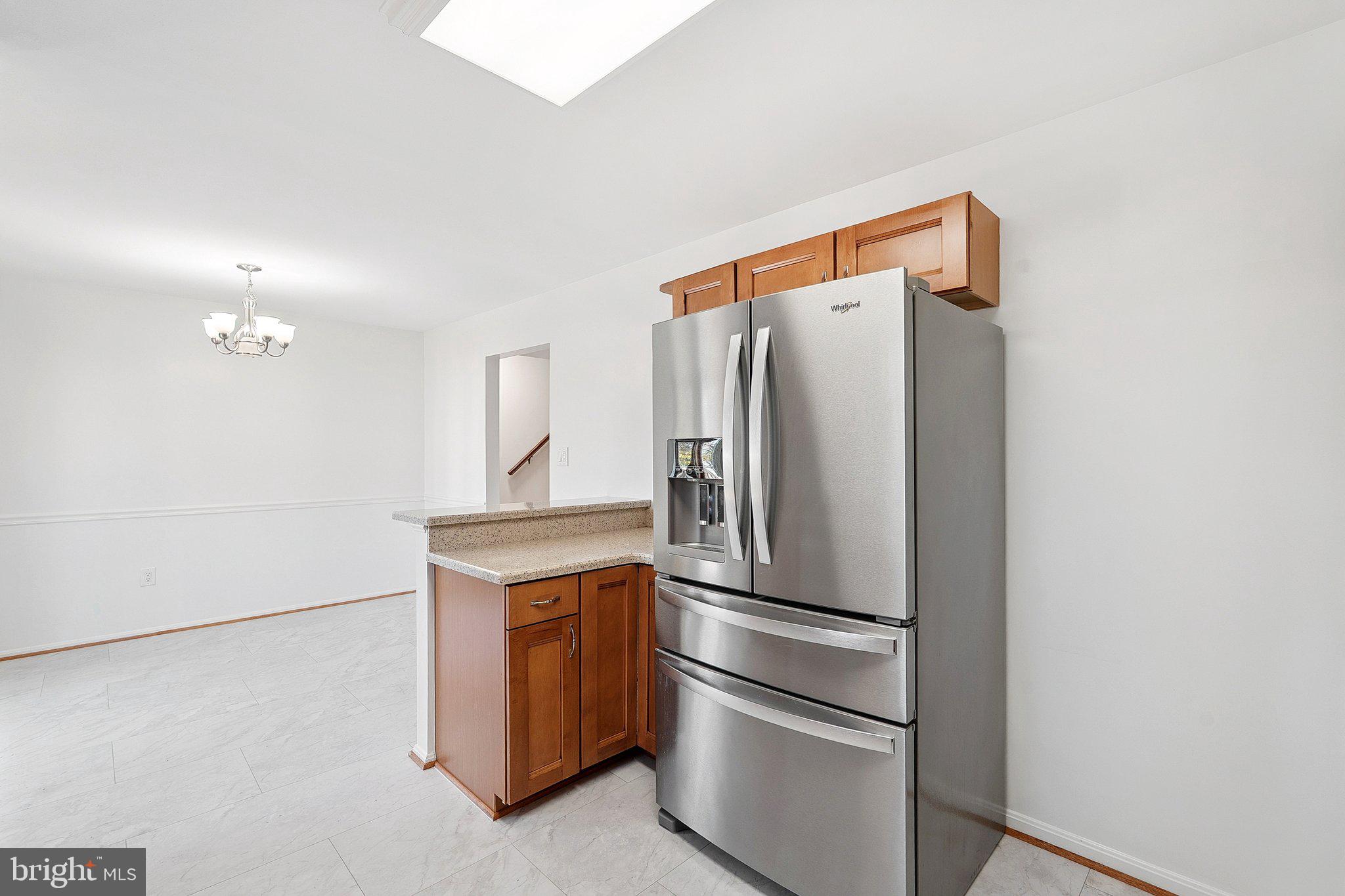 3120 Valentino Court Oakton, VA 22124 - Photo 8 of 25 a metallic refrigerator freezer sitting in a kitchen