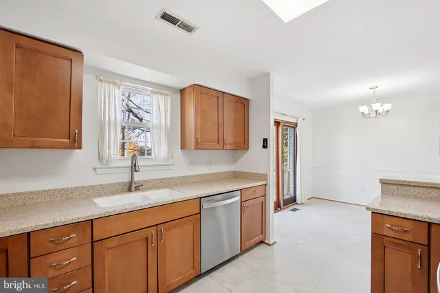 a kitchen with a sink cabinets and window