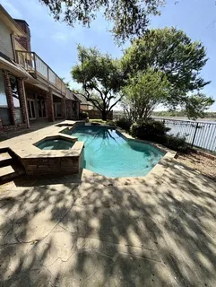 a view of a swimming pool with a yard