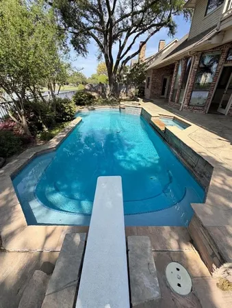 a view of a swimming pool with a yard