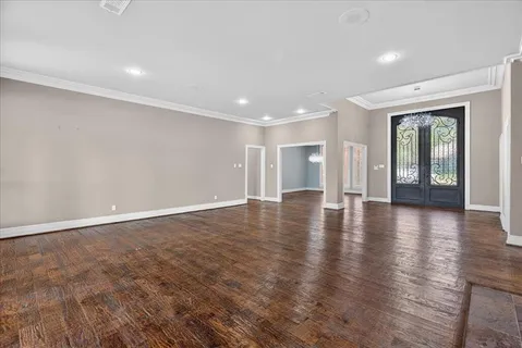 an empty room with wooden floor and fireplace