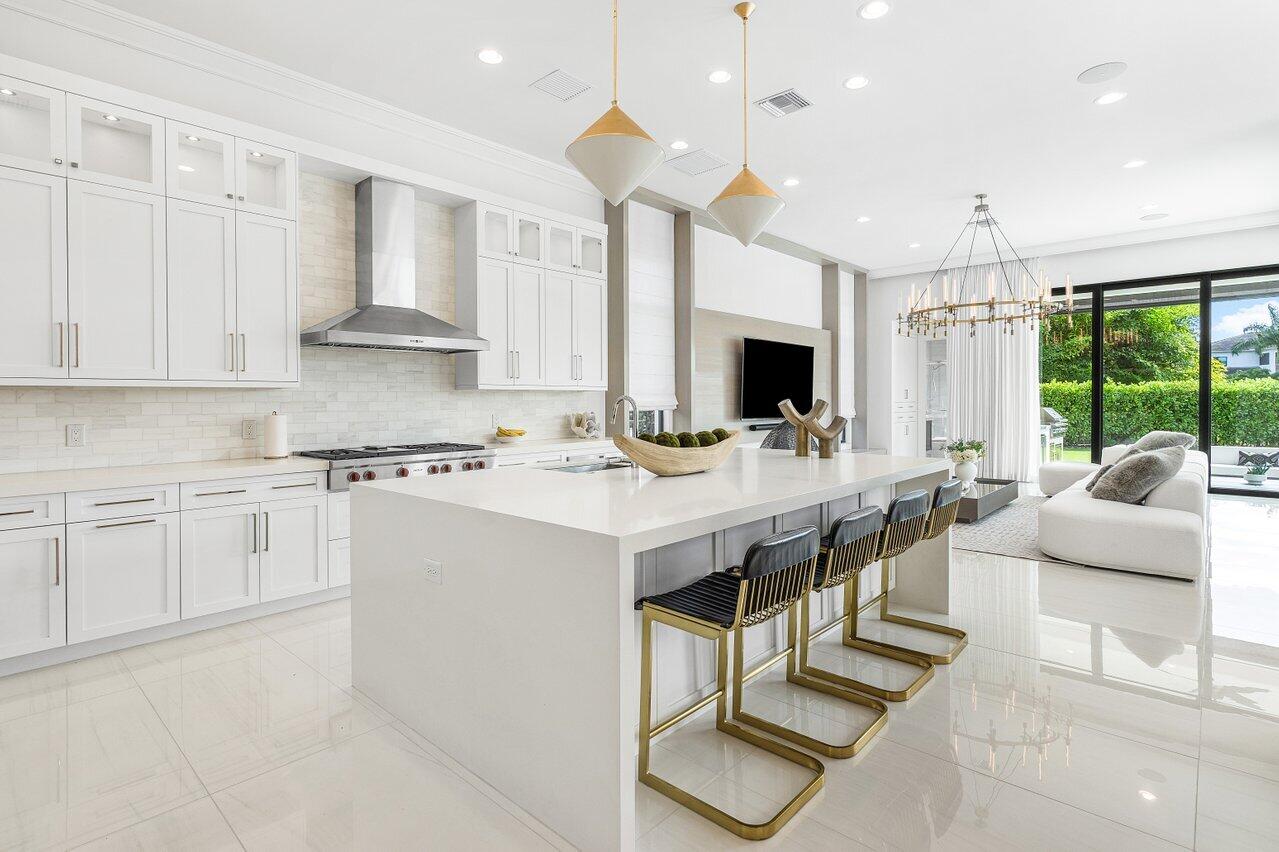 9276 Biaggio Road Boca Raton, FL 33496 - Photo 11 of 70 a kitchen with stainless steel appliances kitchen island granite countertop a sink and a stove
