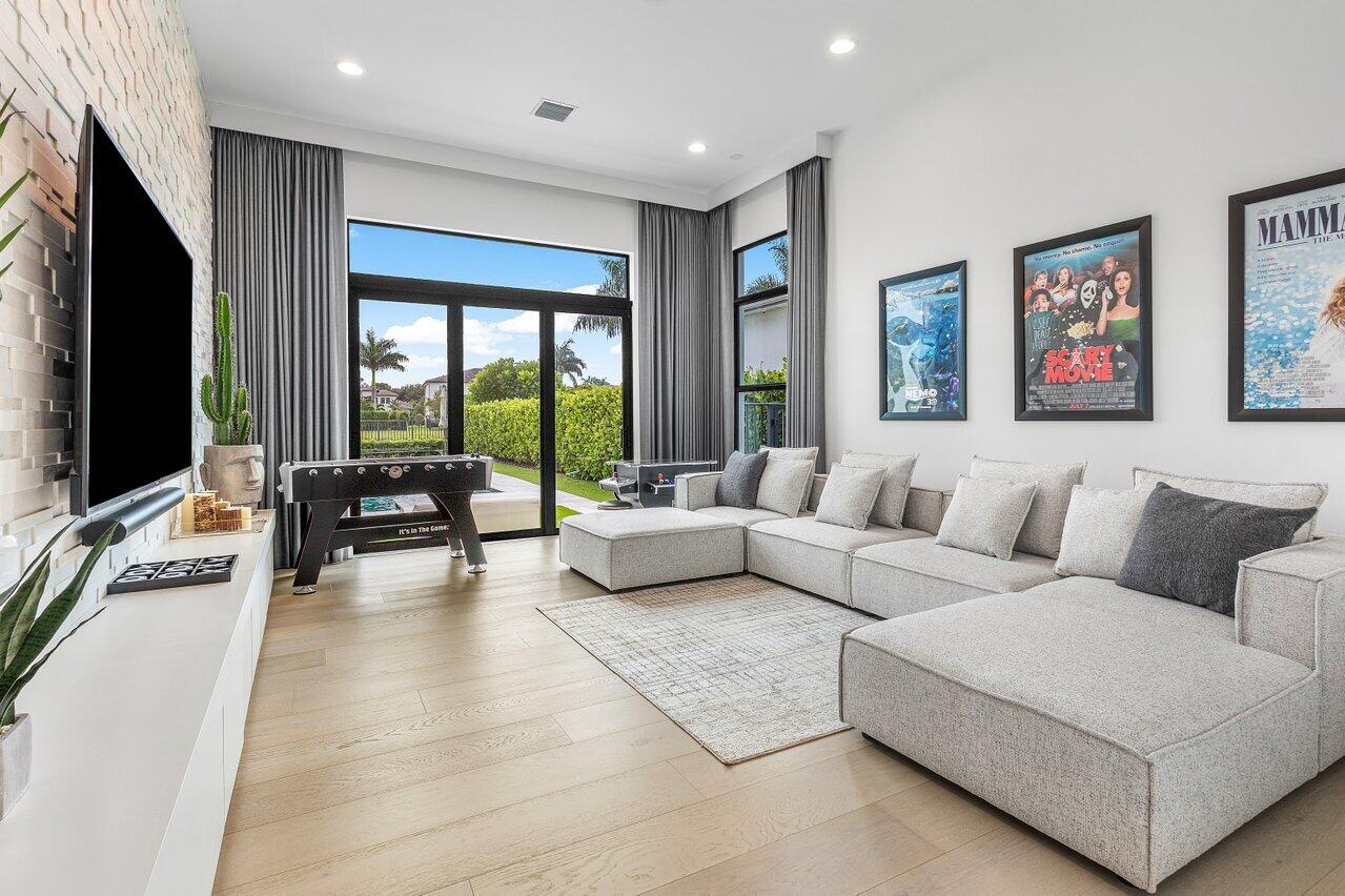 9276 Biaggio Road Boca Raton, FL 33496 - Photo 14 of 70 a living room with furniture flat screen tv and a large window