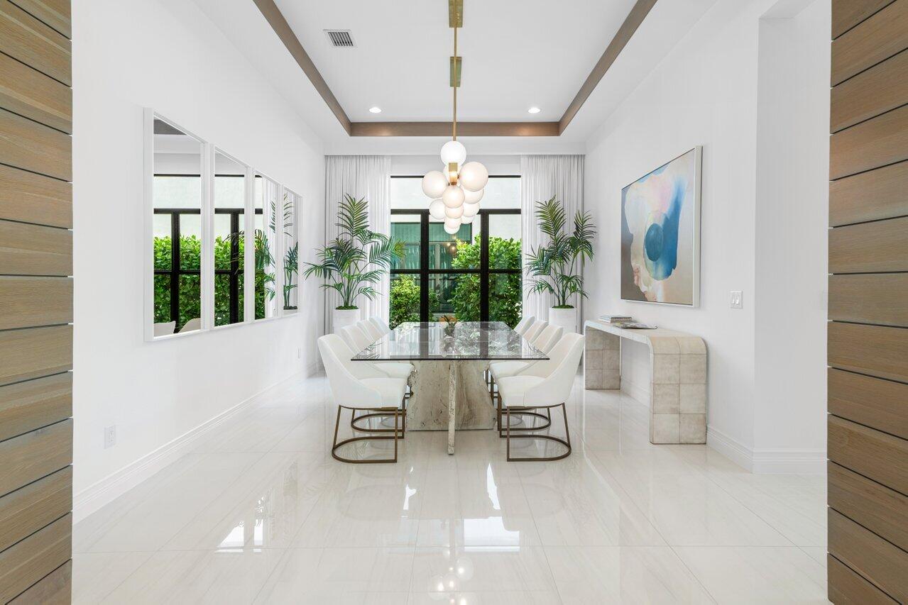 9276 Biaggio Road Boca Raton, FL 33496 - Photo 18 of 70 a dining room with furniture a chandelier and window