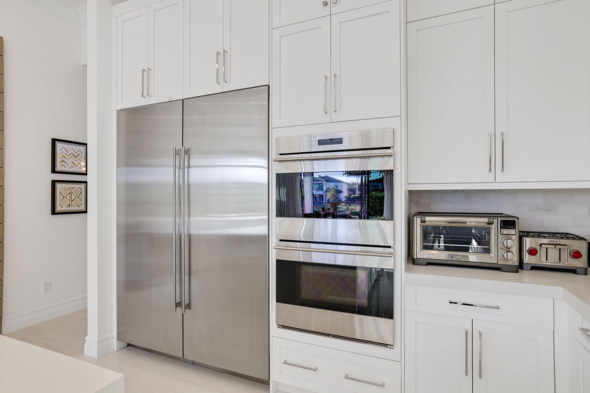 9276 Biaggio Road Boca Raton, FL 33496 - Photo 22 of 70 a kitchen with cabinets and stainless steel appliances