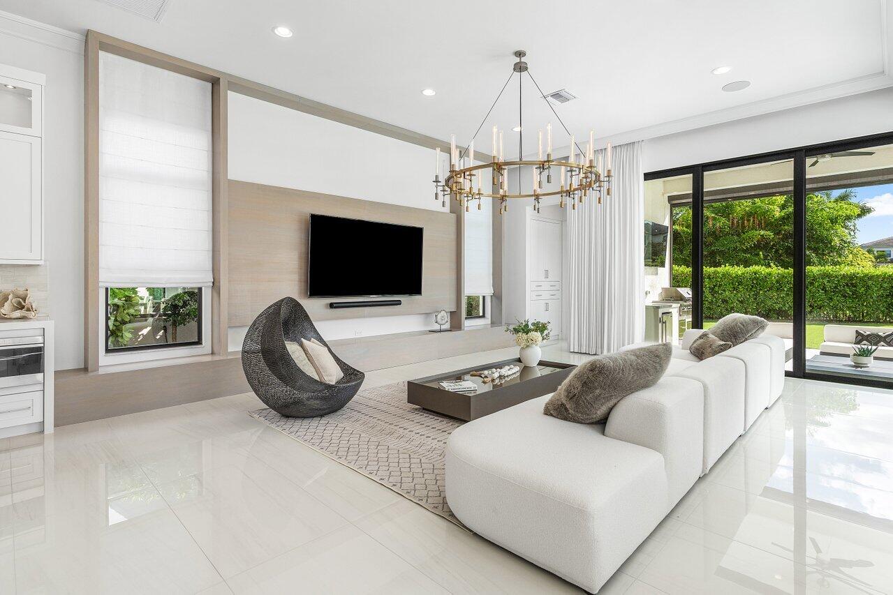 9276 Biaggio Road Boca Raton, FL 33496 - Photo 23 of 70 a living room with furniture a flat screen tv and a large window