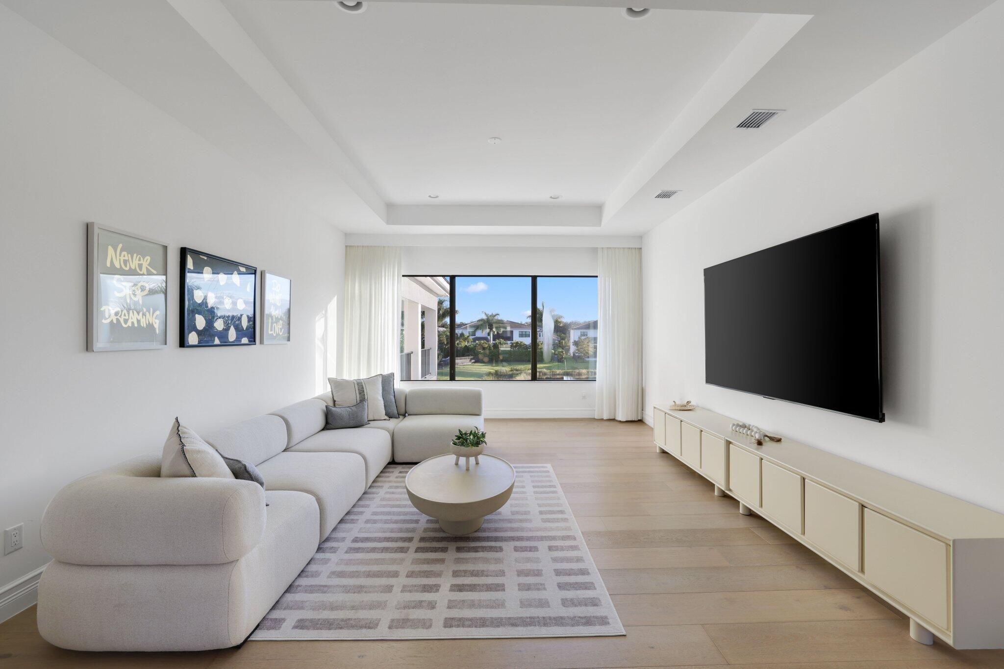 9276 Biaggio Road Boca Raton, FL 33496 - Photo 29 of 70 a living room with furniture and a flat screen tv