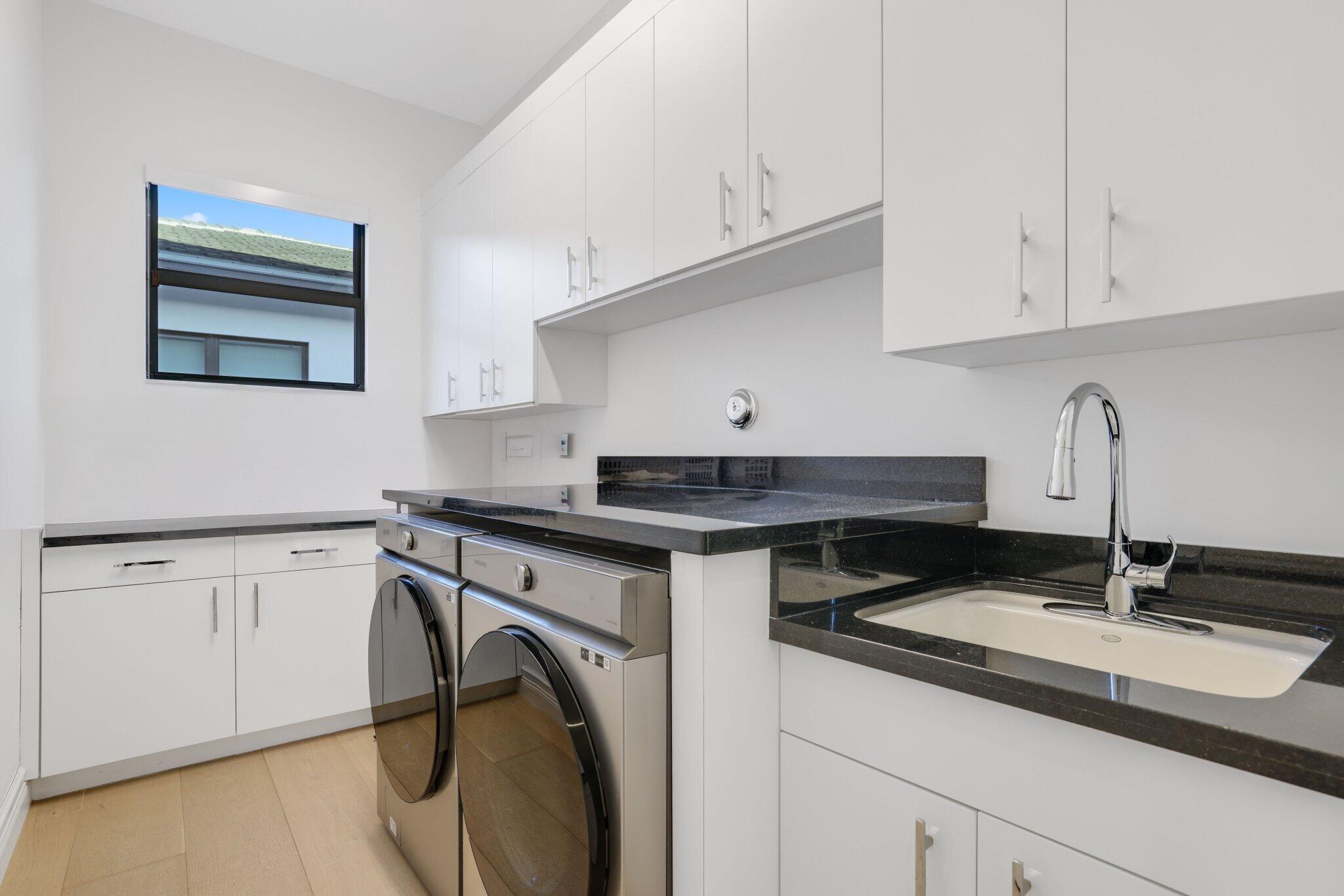 9276 Biaggio Road Boca Raton, FL 33496 - Photo 37 of 70 a kitchen with granite countertop a sink and a stove top oven