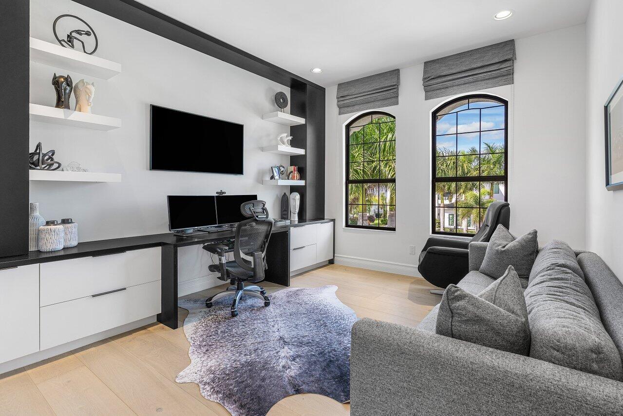 9276 Biaggio Road Boca Raton, FL 33496 - Photo 38 of 70 a living room with furniture tv and a flat screen tv