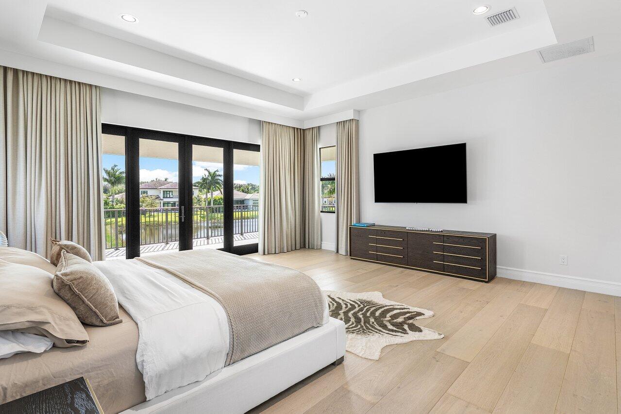 9276 Biaggio Road Boca Raton, FL 33496 - Photo 41 of 70 a bedroom with a bed and a flat screen tv