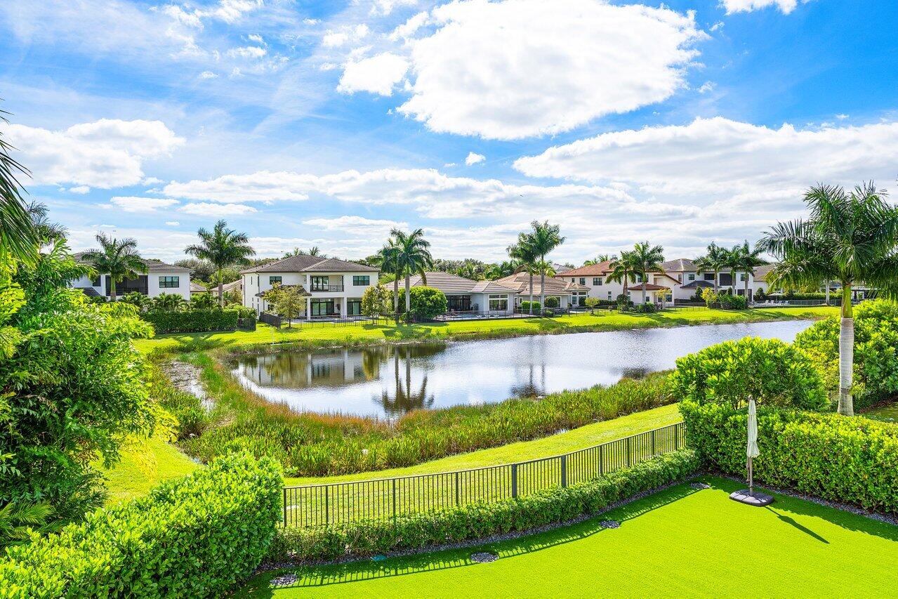 9276 Biaggio Road Boca Raton, FL 33496 - Photo 6 of 70 a view of a lake with a building in the background