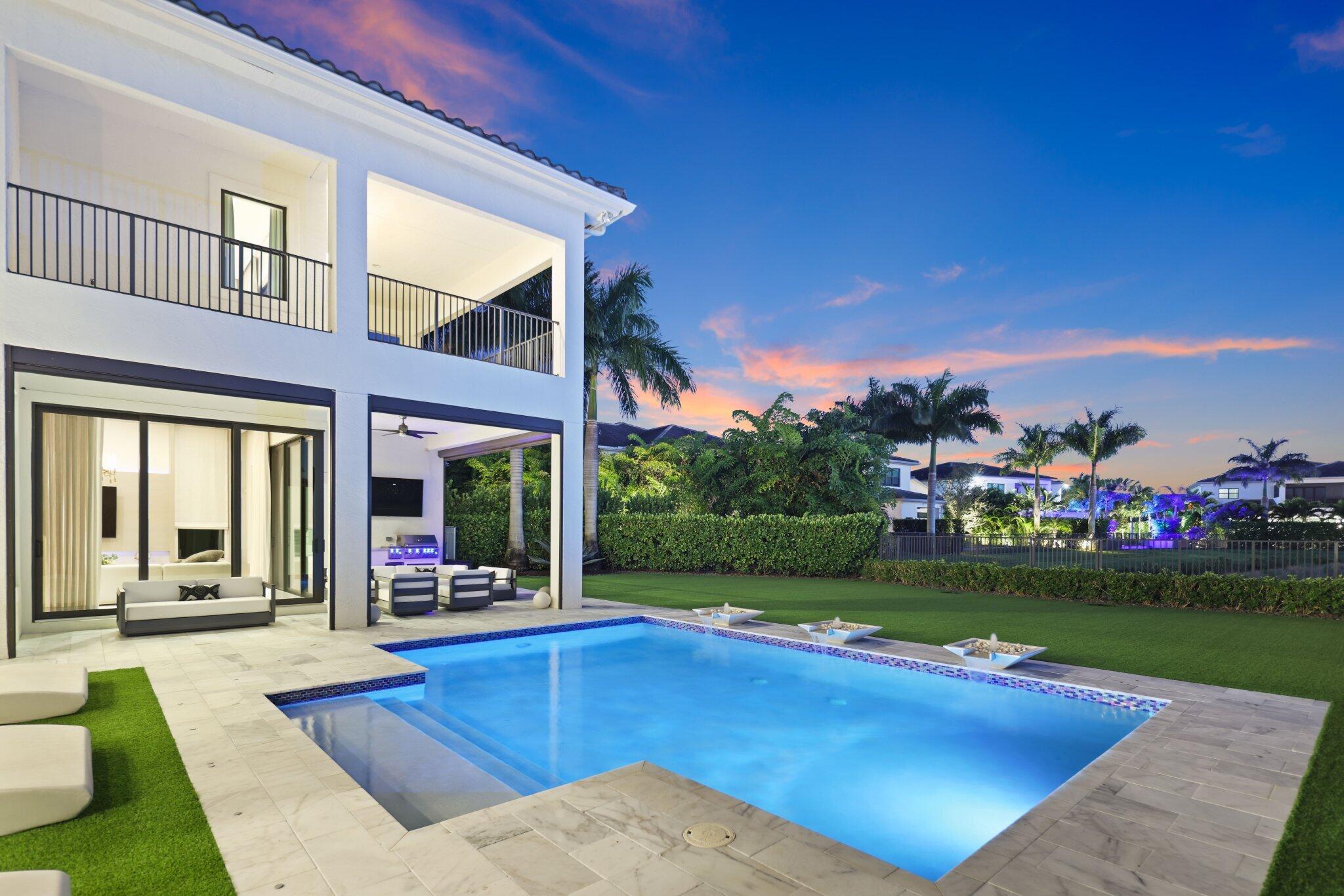 9276 Biaggio Road Boca Raton, FL 33496 - Photo 65 of 70 a view of a house with garden and a patio