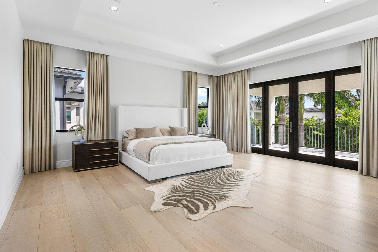 9276 Biaggio Road Boca Raton, FL 33496 - Photo 10 of 70 a spacious bedroom with a bed and a large window